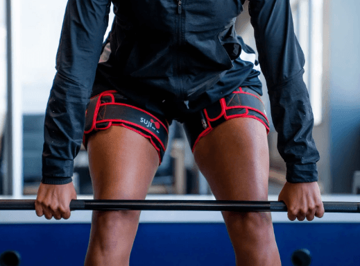 Patient using Blood Flow Restriction therapy to build strength with light weights