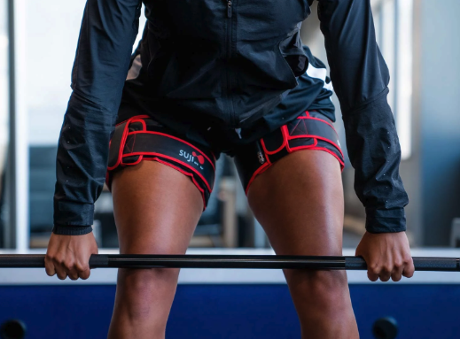 Patient using a BFR cuff during physical therapy exercises